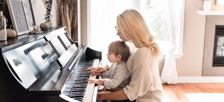 mother and child playing a piano 